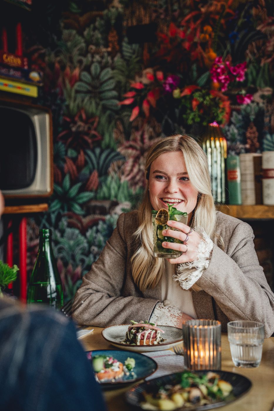 Gast met een cocktail in het cafe van Credible